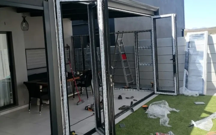Charcoal aluminium folding doors opened up during installation