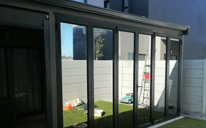 Charcoal aluminium doors closed along a garden room after installation