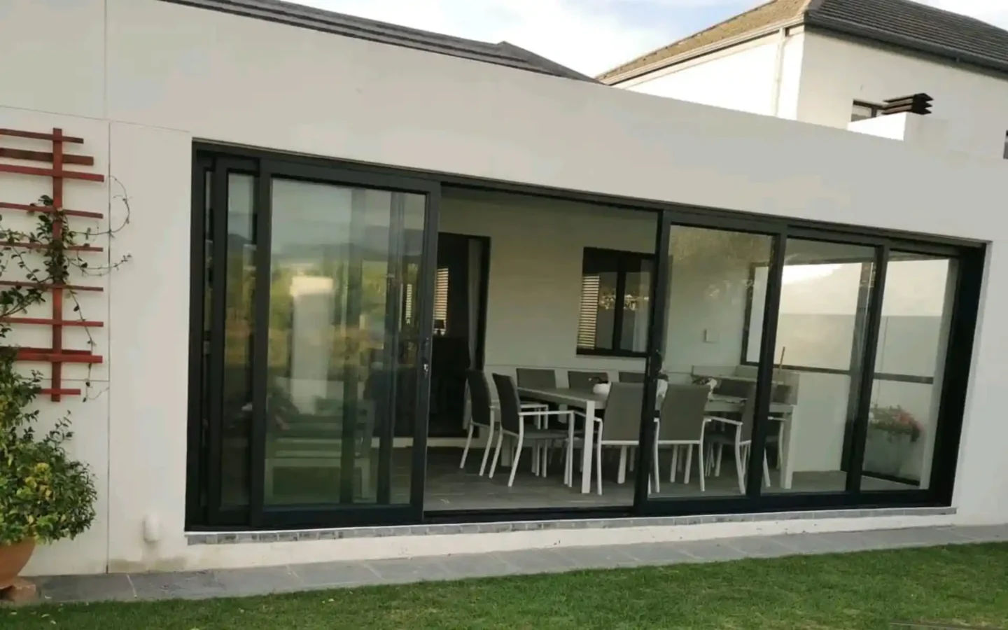 Charcoal aluminium sliding doors opening onto a covered patio
