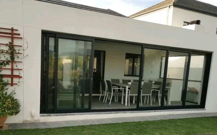 Charcoal aluminium sliding doors opening onto a covered patio