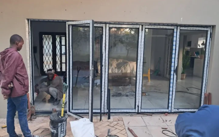 Installation team fitting aluminium stacking doors