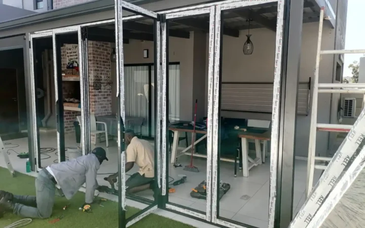 Two installers working on aluminium folding doors